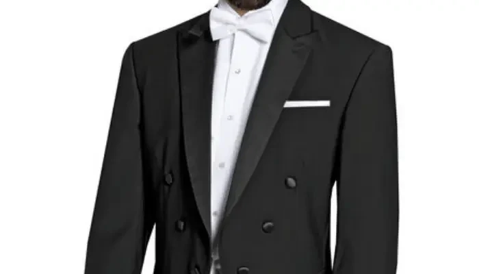 Groom wearing a black tuxedo with a white bow tie and pocket square.