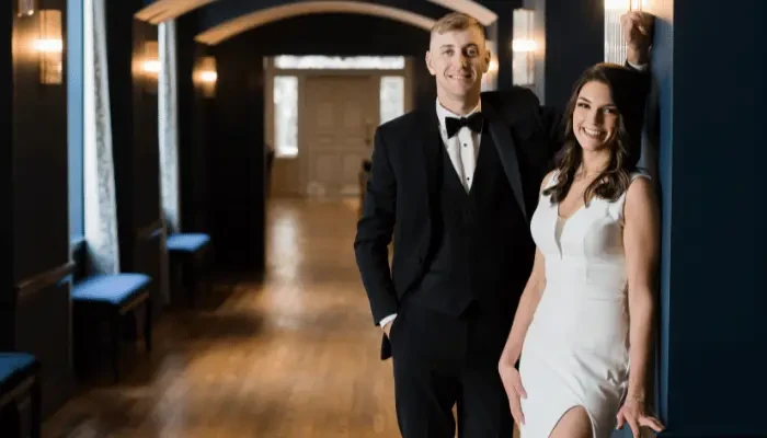 1. Bride and groom posing together, with the groom in a black tuxedo and the bride in a white wedding dress.