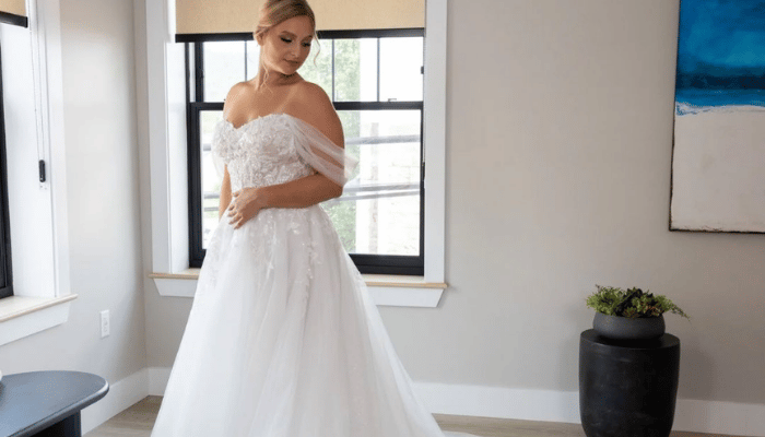 Bride wearing an off-the-shoulder ball gown wedding dress with a lace bodice and full tulle skirt