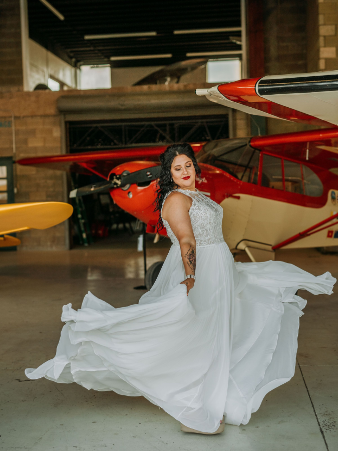 A bride in a plus-size wedding gown from Formalities
