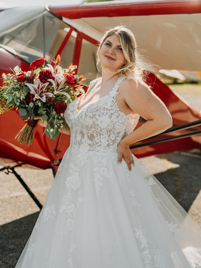 A curvy bride in a plus-size wedding dress from Formalities