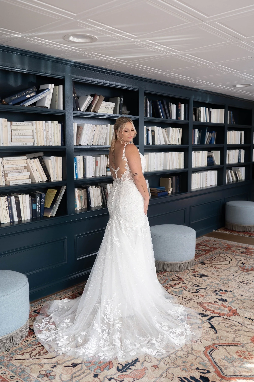 Bride wearing a floral lace wedding dress and holding a bouquet at Formalities