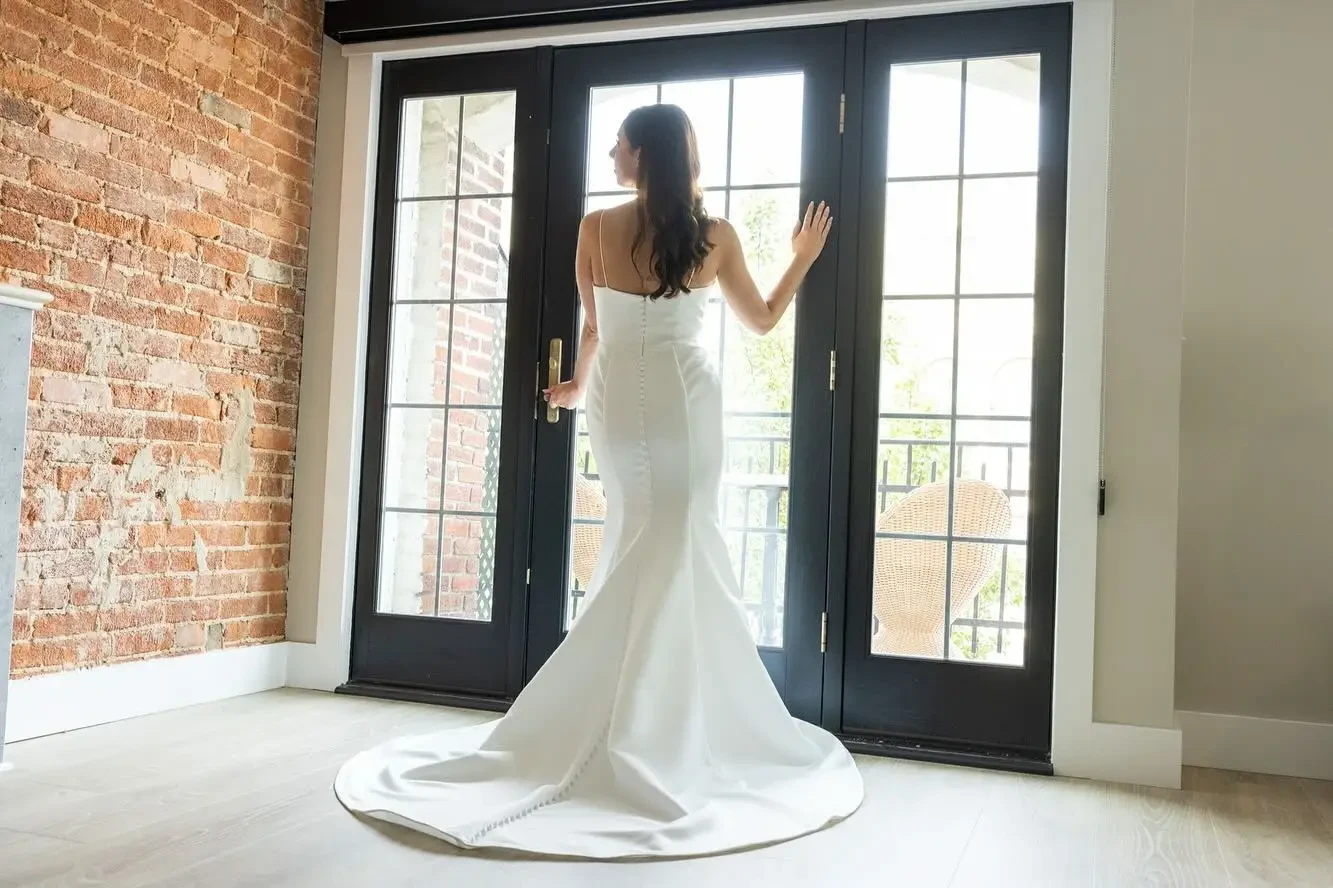 This satin fit-and-flare features a full-length button detail that never goes out of style— perfect