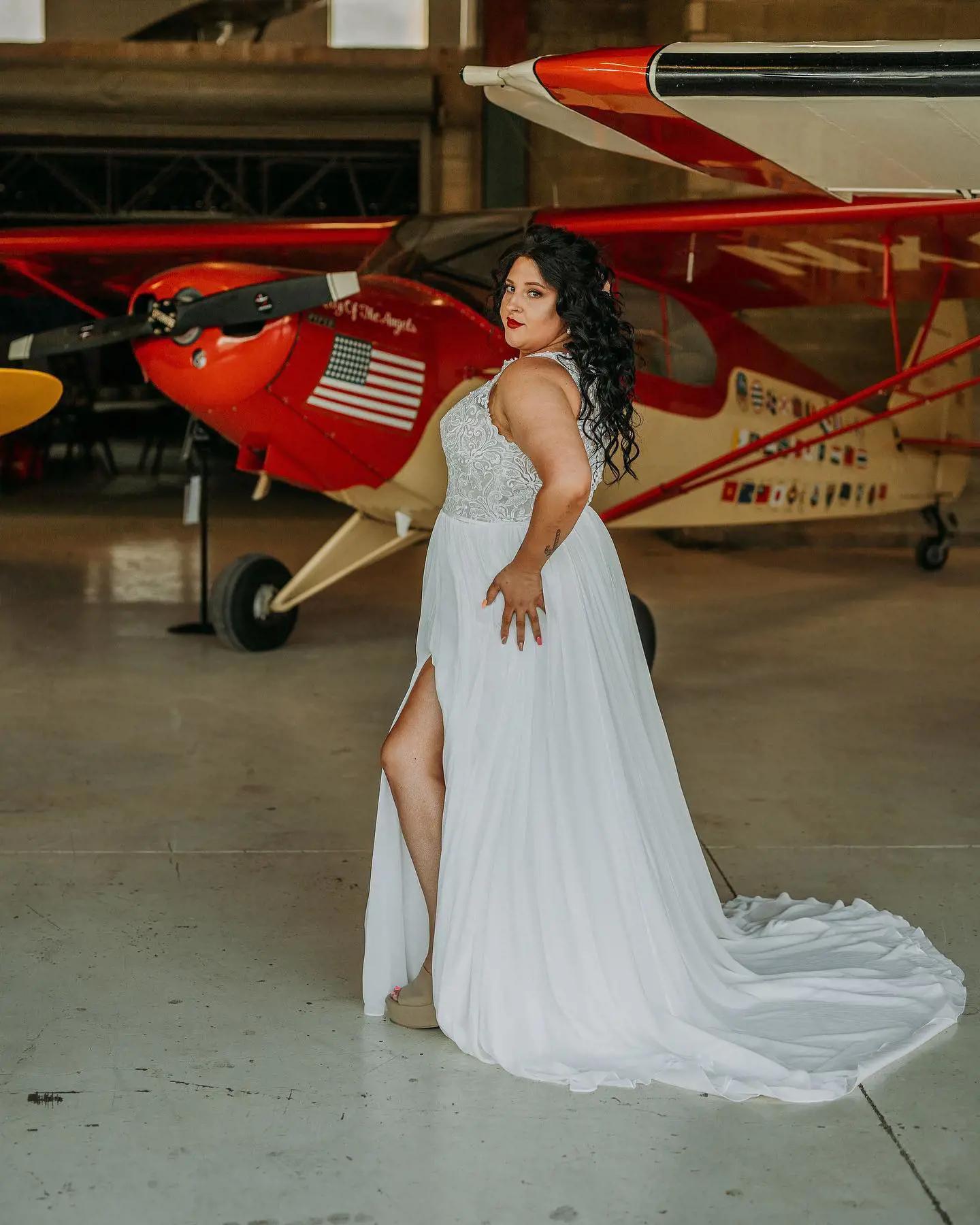 Model wearing a white gown near the airplane 4